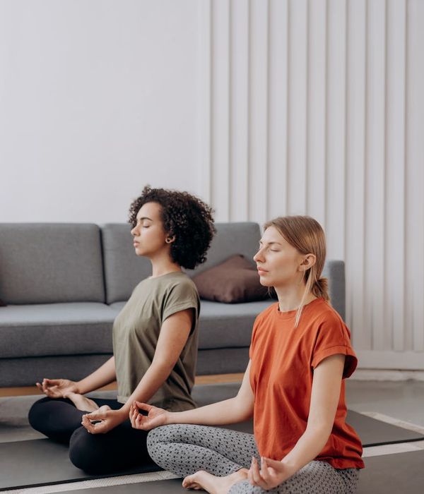 A person practicing yoga in a minimalist room with natural light.